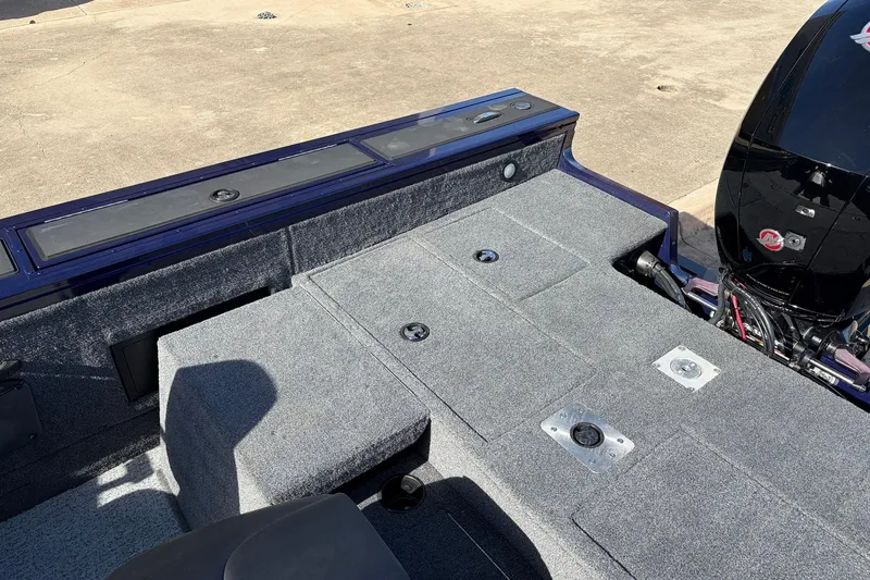 Slide: The Image of 2024 Tracker Targa V-18 Combo boat interior with carpeted deck and motor. - 52