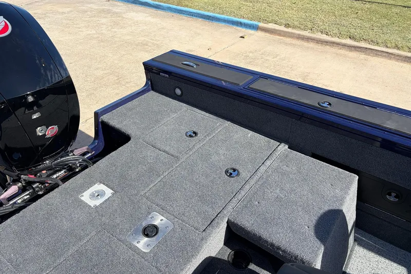 Slide: The Image of 2024 Tracker Targa V-18 Combo boat interior with carpeted deck and motor. - 53