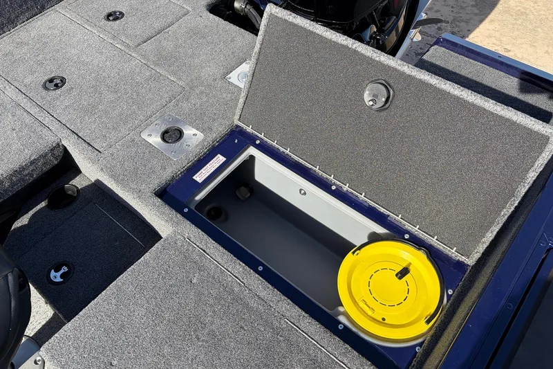 Slide: The Image of 2024 Tracker Targa V-18 Combo boat interior with open storage compartment. - 54