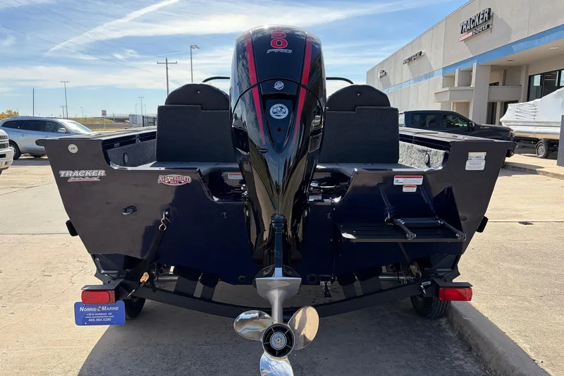 Slide: The Image of 2024 Tracker Targa V-18 Combo boat rear view with outboard motor in dealership lot. - 6