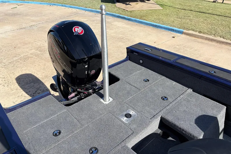 Slide: The Image of 2024 Tracker Targa V-18 Combo boat with Mercury outboard motor, gray deck, and fishing pole holder. - 61