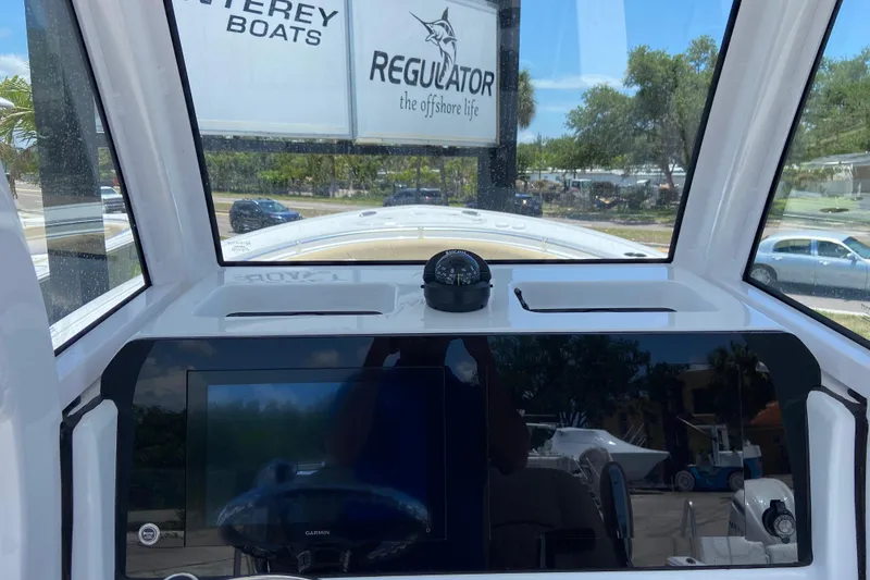 Slide: The Image of 2026 Sportsman Heritage 231 Center Console dashboard with compass and Garmin display. - 14