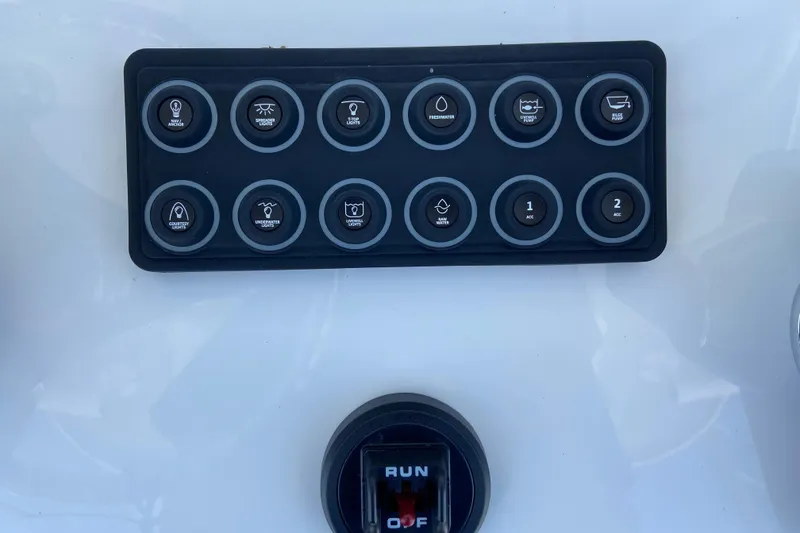Slide: The Image of Control panel of 2026 Sportsman Heritage 231 Center Console boat with labeled buttons. - 17