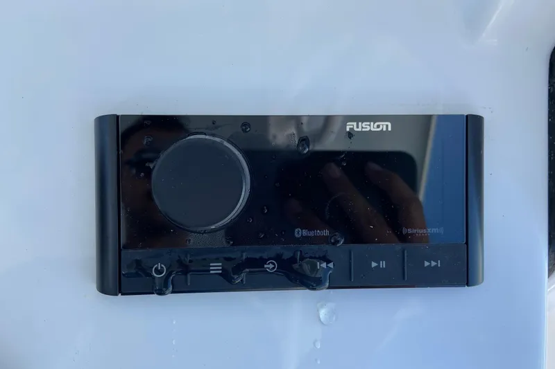 Slide: The Image of Fusion audio system on 2026 Sportsman Heritage 231 Center Console boat, featuring Bluetooth and SiriusXM. - 18