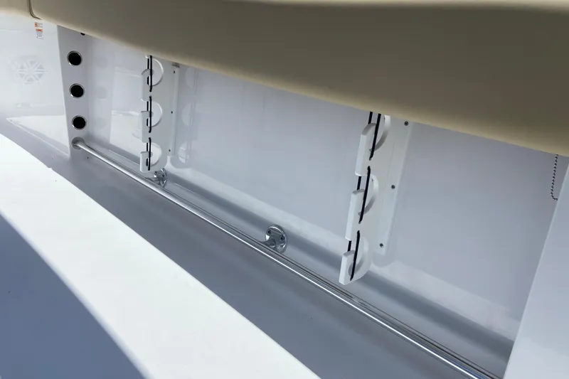 Slide: The Image of 2026 Sportsman Heritage 231 Center Console interior detail with rod holders and storage. - 21