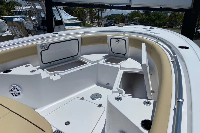 Slide: The Image of 2026 Sportsman Heritage 231 Center Console boat interior with storage compartments and seating. - 24