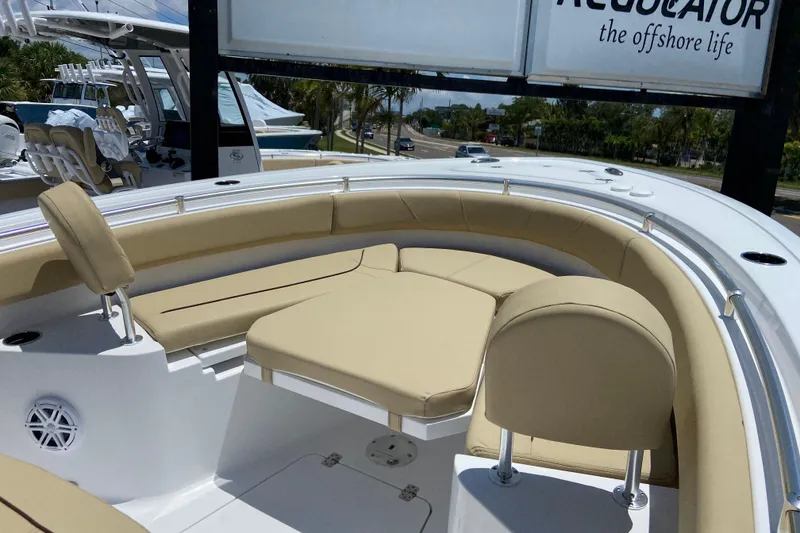 Slide: The Image of 2026 Sportsman Heritage 231 Center Console boat with beige seating and sleek design. - 29
