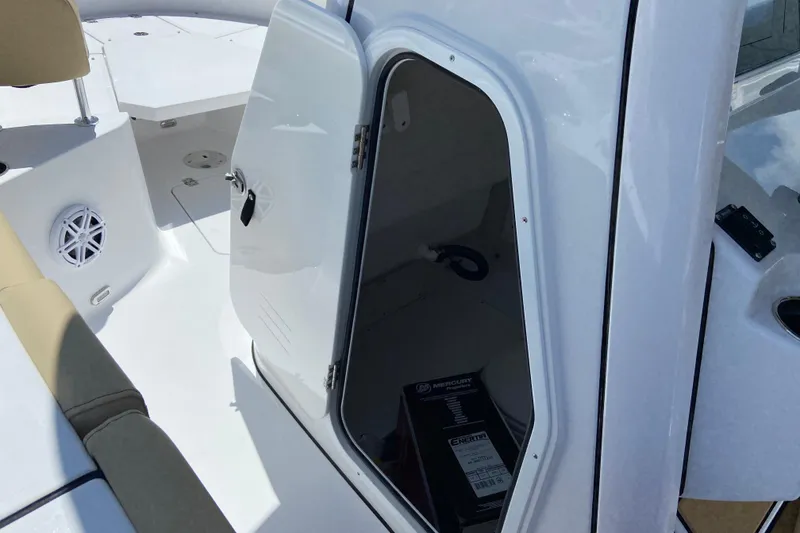 Slide: The Image of 2026 Sportsman Heritage 231 Center Console boat interior with open storage compartment. - 33
