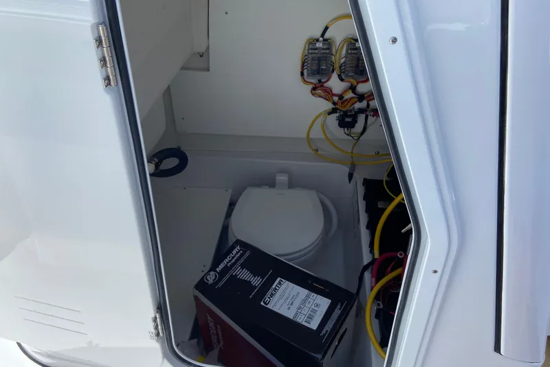 Slide: The Image of Interior view of 2026 Sportsman Heritage 231 Center Console boat, featuring wiring and storage. - 35