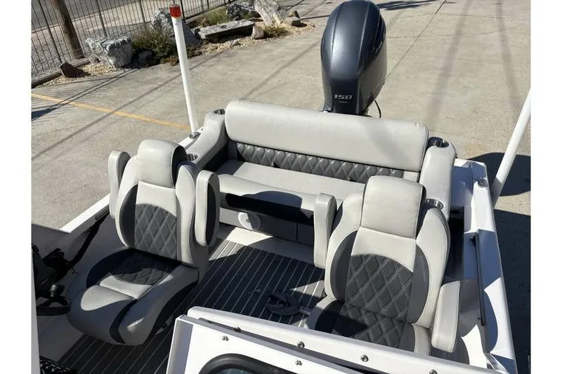 Slide: The Image of Interior of a 1997 Scully's 18 WT boat with modern seating and motor. - 11