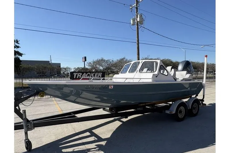 Slide: The Image of 1997 Scully's 18 WT boat on trailer, parked outdoors under clear blue sky. - 3
