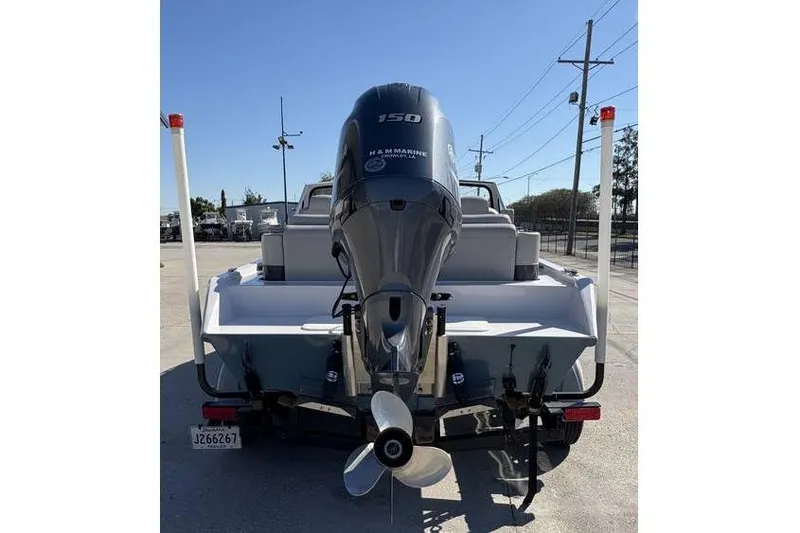 Slide: The Image of 1997 Scully's 18 WT boat with a 150 HP outboard motor, parked on a trailer. - 5
