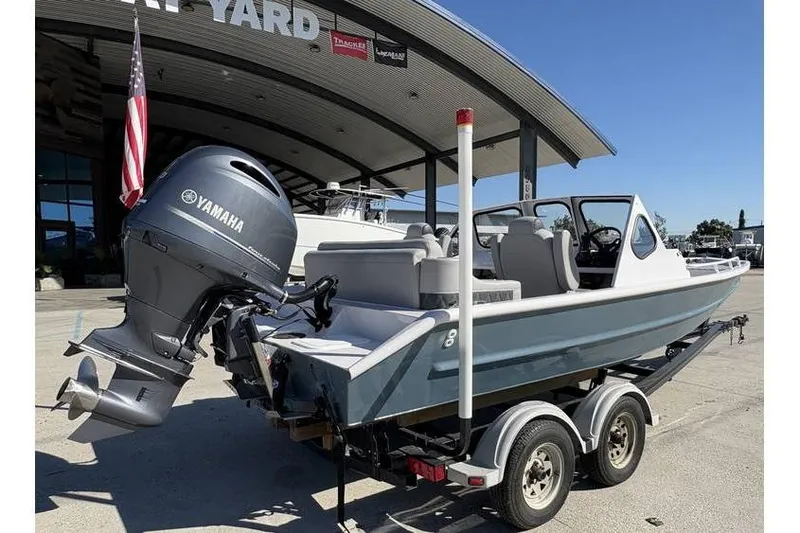 Slide: The Image of 1997 Scully's 18 WT boat with Yamaha motor on trailer at marina. - 6