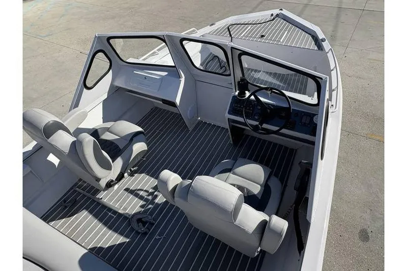 Slide: The Image of Interior of a 1997 Scully's 18 WT boat with seating and steering console. - 8