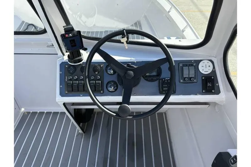 Slide: The Image of Steering console of a 1997 Scully's 18 WT boat with gauges and controls. - 9