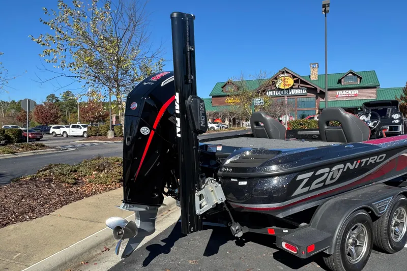 Slide: The Image of 2023 Nitro Z20 Pro boat parked outside Bass Pro Shops, showcasing sleek design and powerful engine. - 1