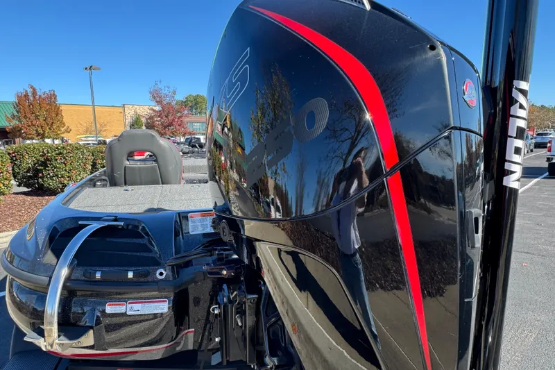 Slide: The Image of 2023 Nitro Z20 Pro boat with sleek black and red design, parked outdoors. - 2