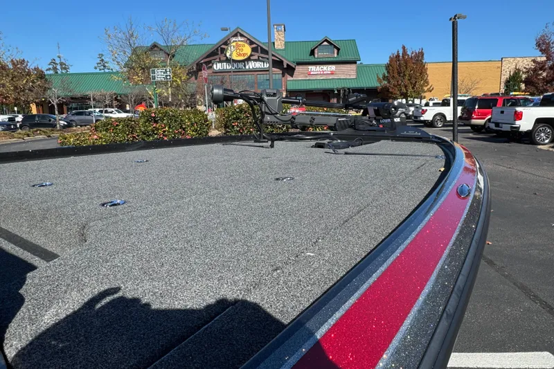 Slide: The Image of 2023 Nitro Z20 Pro boat parked outside Bass Pro Shops, showcasing sleek design and modern features. - 7