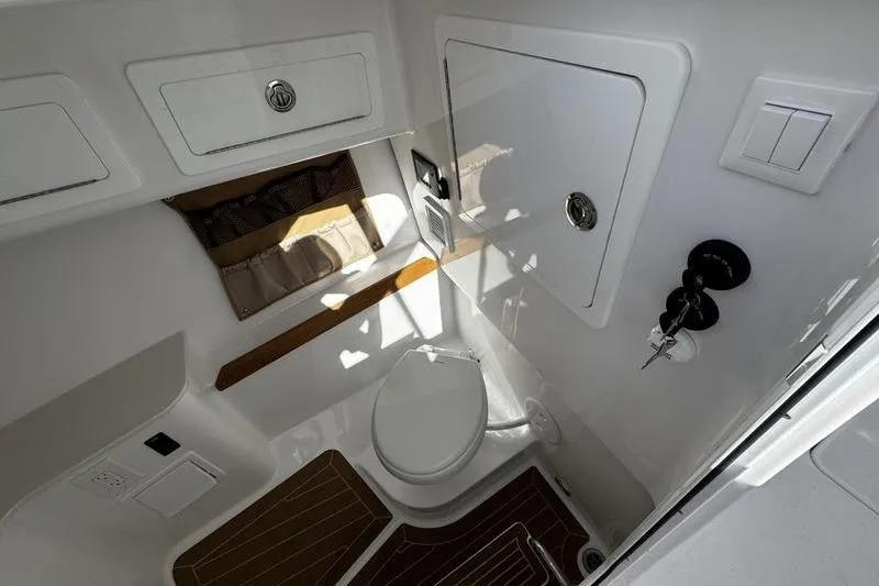Slide: The Image of 2026 Southport 33 DC boat bathroom with modern fixtures and storage compartments. - 11