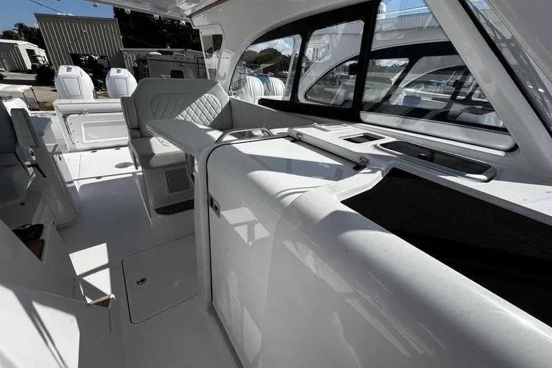 Slide: The Image of 2026 Southport 33 DC boat interior with modern seating and sleek design. - 14