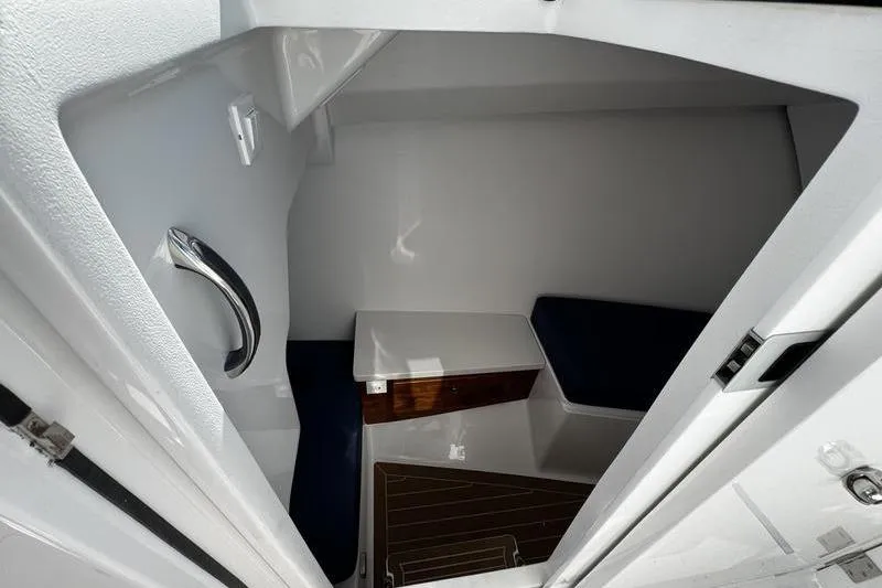 Slide: The Image of Interior cabin of 2026 Southport 33 DC boat with seating and wooden accents. - 15