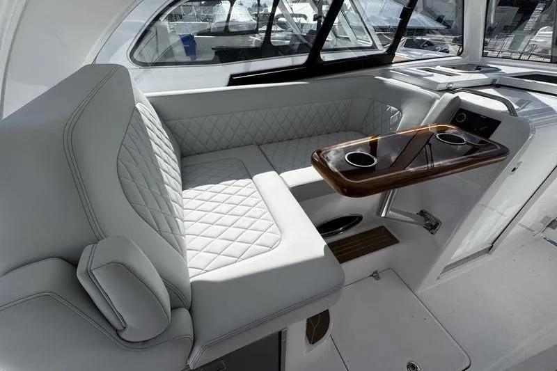 Slide: The Image of Luxurious interior of 2026 Southport 33 DC boat with plush seating and elegant table. - 26