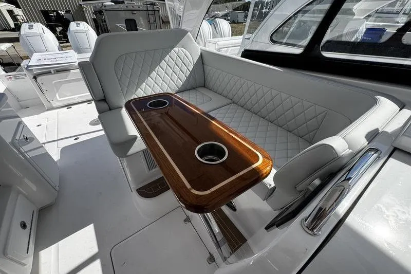 Slide: The Image of Luxurious interior of 2026 Southport 33 DC boat with elegant seating and wooden table. - 27