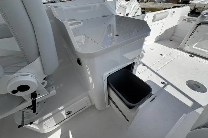 Slide: The Image of 2026 Southport 33 DC boat interior with storage compartment and seating area. - 29