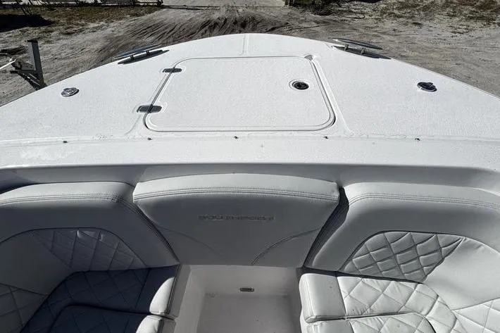 Slide: The Image of 2026 Southport 33 DC boat interior with white cushioned seating and deck. - 3