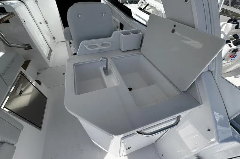 Slide: The Image of 2026 Southport 33 DC boat interior with sink and storage area. - 30