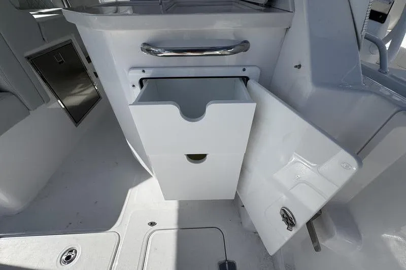 Slide: The Image of 2026 Southport 33 DC boat interior with open storage compartment and drawer. - 31