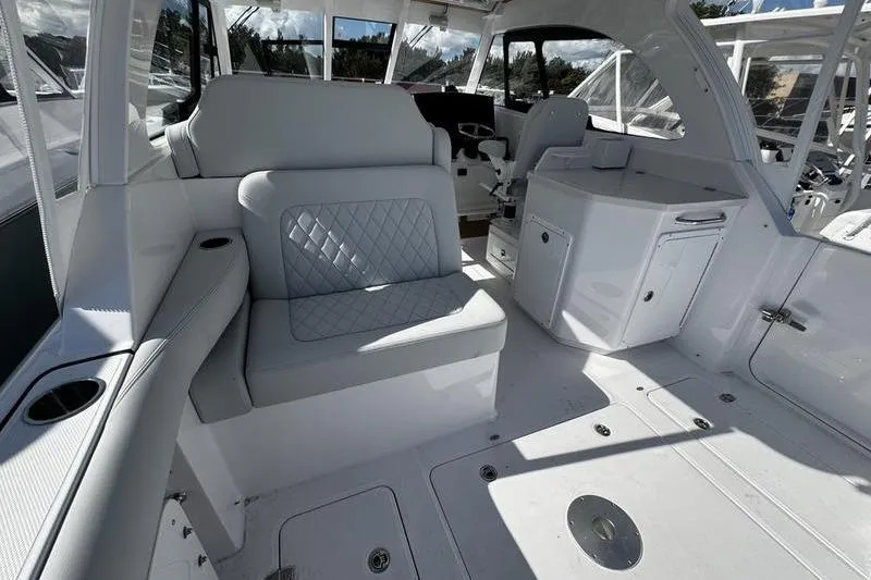 Slide: The Image of 2026 Southport 33 DC boat interior with white seating and modern design. - 33