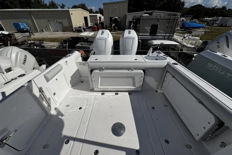 Slide: The Image of 2026 Southport 33 DC boat deck with dual outboard engines, spacious layout, and storage compartments. - 34