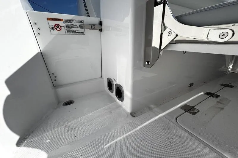 Slide: The Image of 2026 Southport 33 DC boat interior detail with storage compartments and safety labels. - 36