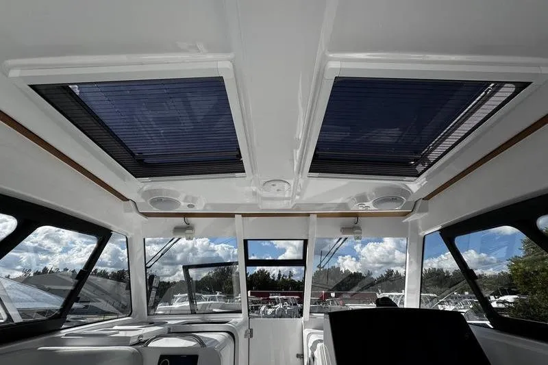 Slide: The Image of Interior view of 2026 Southport 33 DC boat with skylights and panoramic windows. - 38
