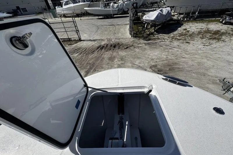 Slide: The Image of Open hatch on 2026 Southport 33 DC boat, showing storage compartment. - 4