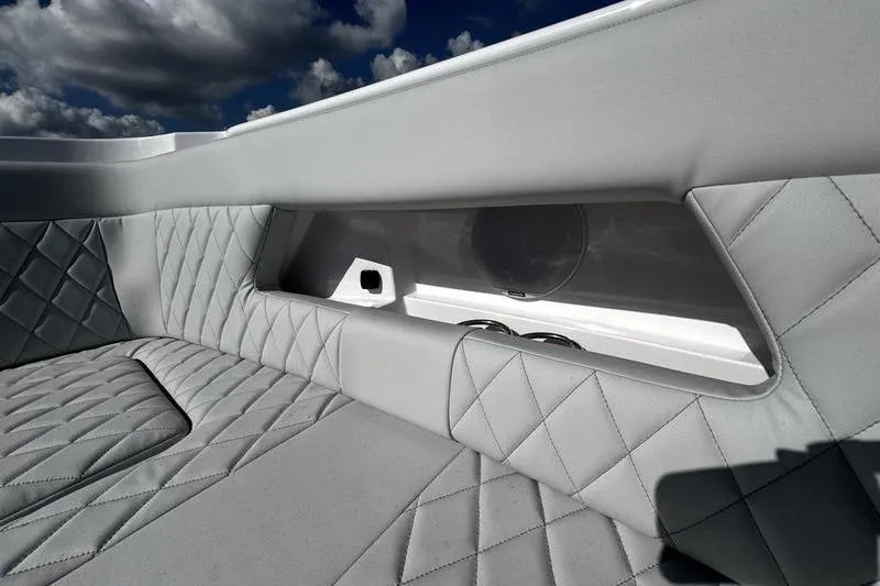 Slide: The Image of Luxurious interior of 2026 Southport 33 DC boat with quilted seating and cup holders. - 8