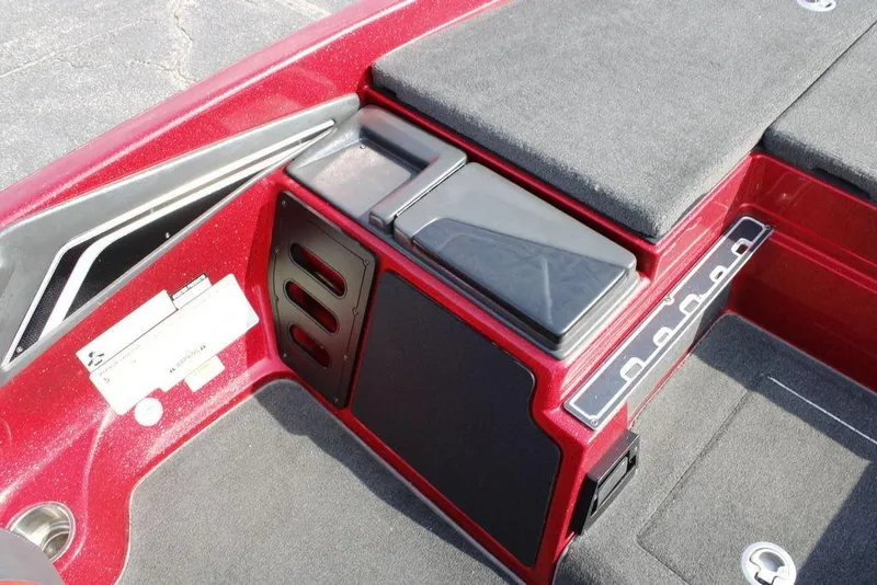 Slide: The Image of 2016 Skeeter FX20 boat interior with red and black design, featuring storage compartments. - 2