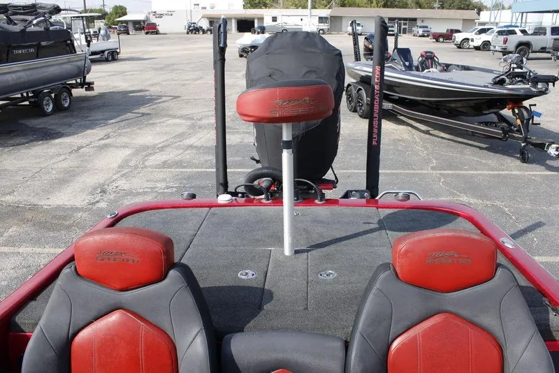 Slide: The Image of 2016 Skeeter FX20 boat interior with red seats and fishing equipment. - 21