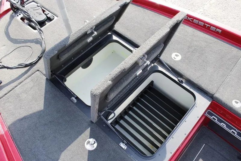 Slide: The Image of 2016 Skeeter FX20 boat storage compartments with open lids, showcasing interior space. - 31