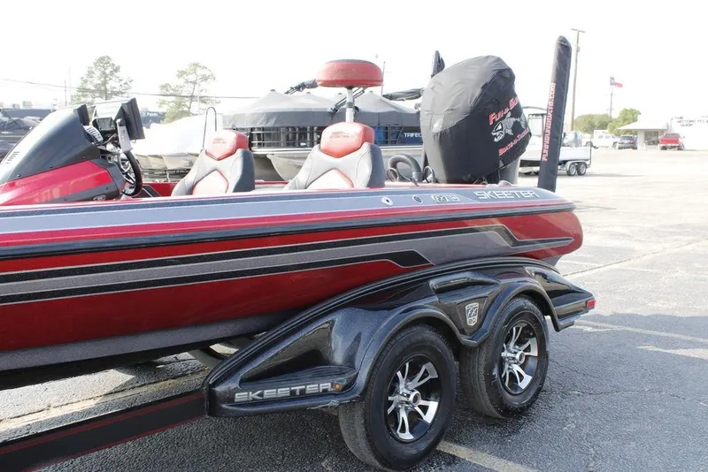 Slide: The Image of 2016 Skeeter FX20 bass boat with dual seats and sleek design on a trailer. - 4