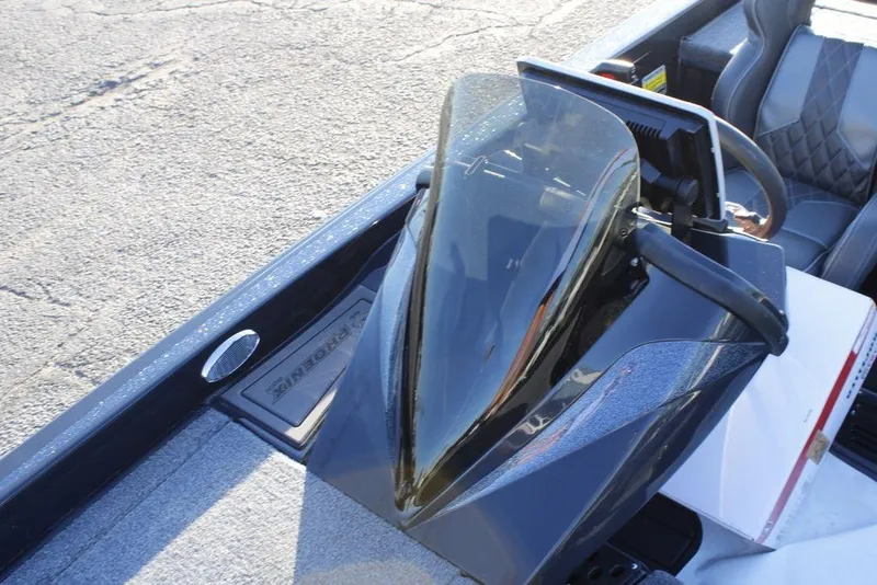 Slide: The Image of 2026 Phoenix 921 ELITE boat console with windshield and seating detail. - 15