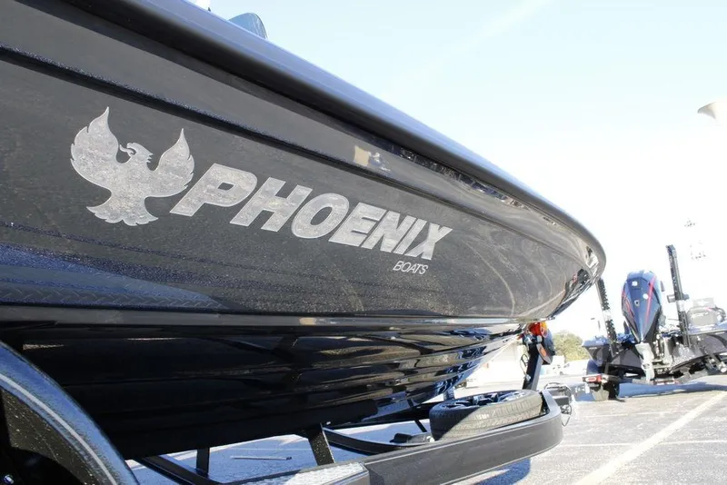 Slide: The Image of 2026 Phoenix 921 ELITE boat, sleek design, parked on a trailer, side view. - 18