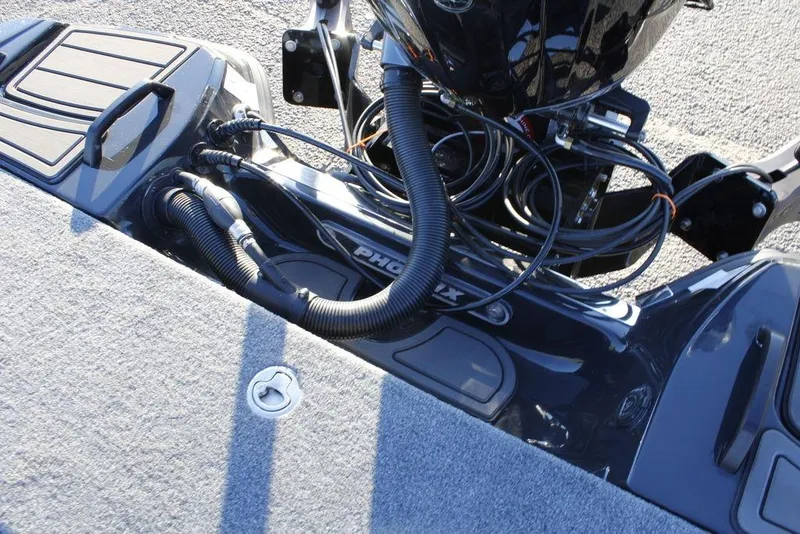 Slide: The Image of 2026 Phoenix 921 ELITE boat deck with cables and motor components. - 19