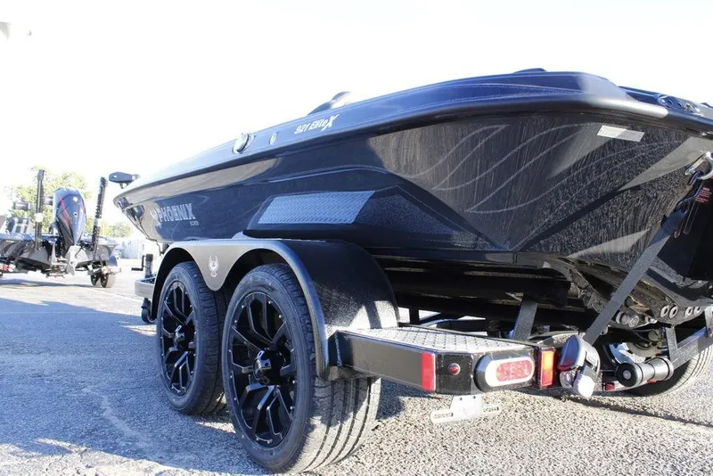 Slide: The Image of 2026 Phoenix 921 ELITE boat on trailer, showcasing sleek design and black wheels. - 3