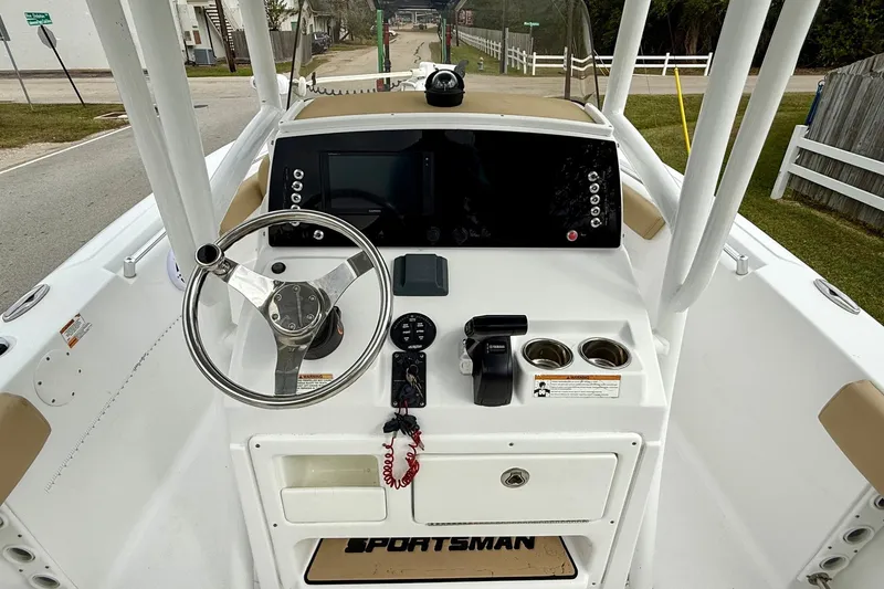 Slide: The Image of 2019 Sportsman Heritage 211 Center Console boat dashboard with steering wheel and controls. - 10