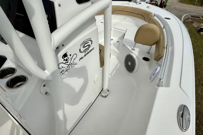 Slide: The Image of 2019 Sportsman Heritage 211 Center Console boat interior with seating and cup holders. - 14