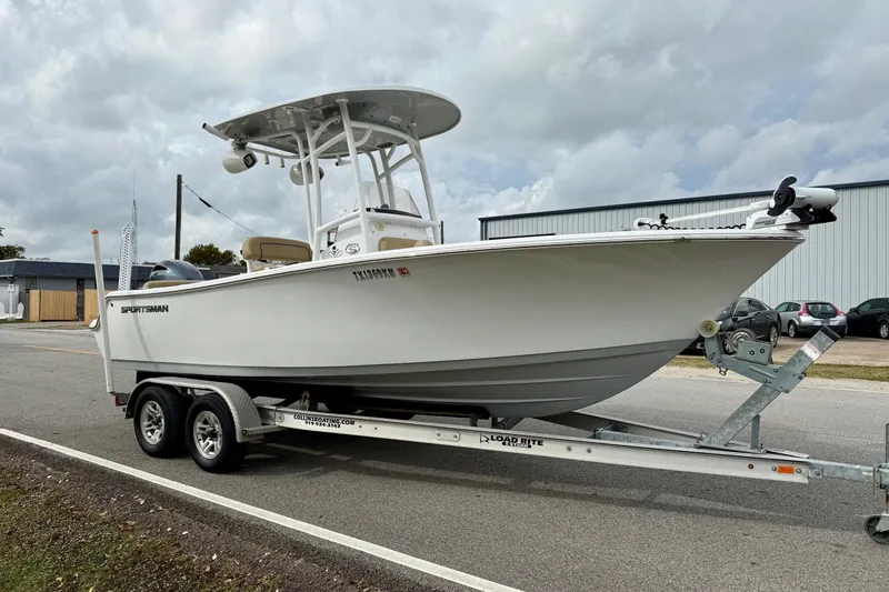 Slide: The Image of 2019 Sportsman Heritage 211 Center Console boat on trailer, parked outdoors. - 5