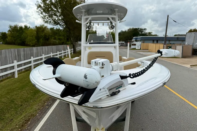 Slide: The Image of 2019 Sportsman Heritage 211 Center Console boat with trolling motor on a road. - 6