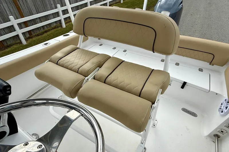 Slide: The Image of 2019 Sportsman Heritage 211 Center Console boat with beige cushioned seating. - 9